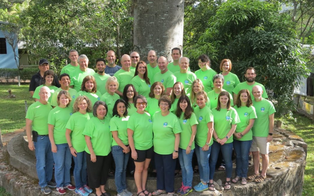 Picture of mission team posing under a tree