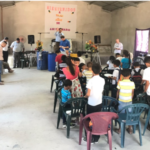 Pastor Maurcio prays over the mission team, the volunteers and children in his congregation in Coyolar